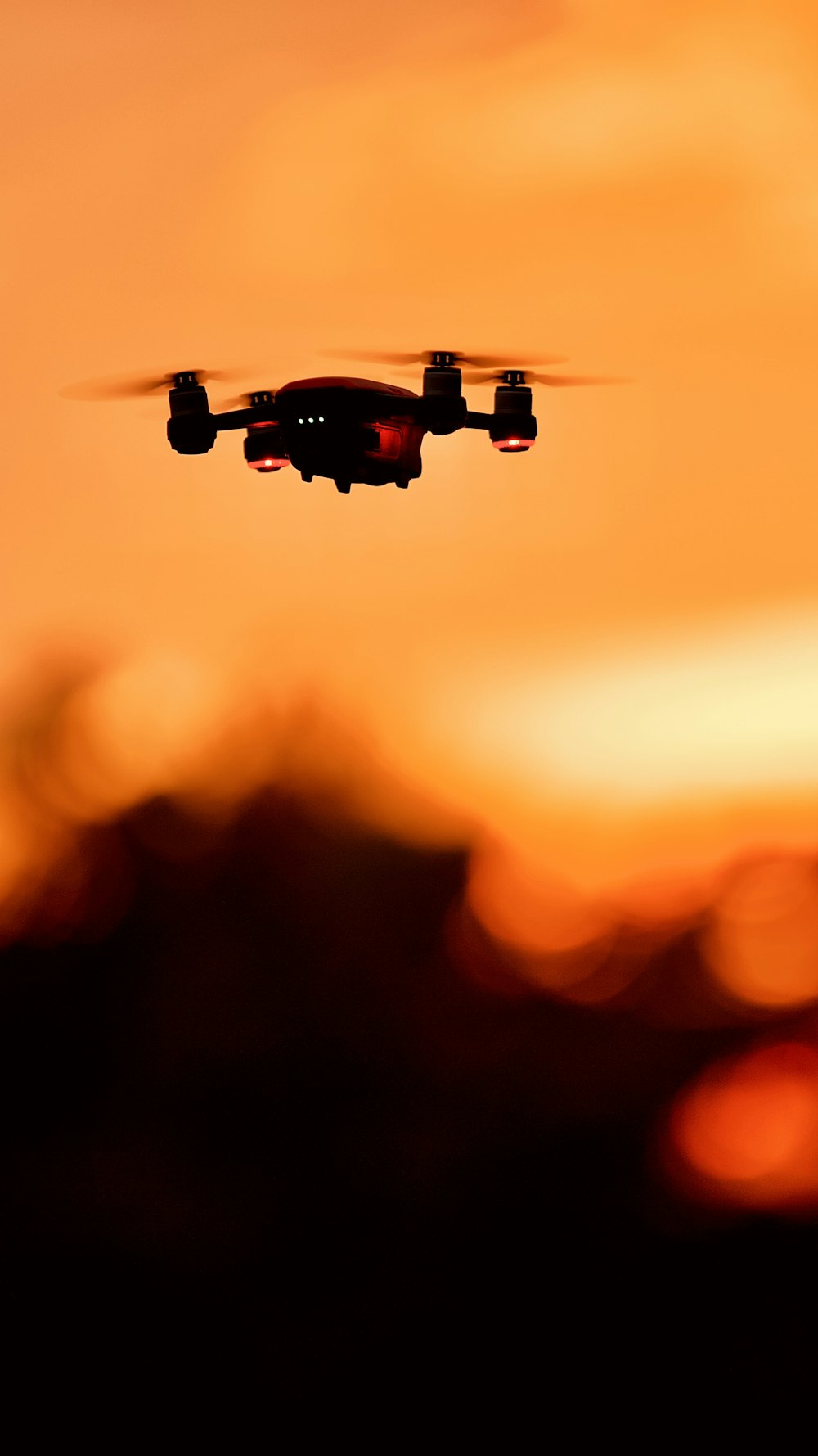 black and orange drone in mid air