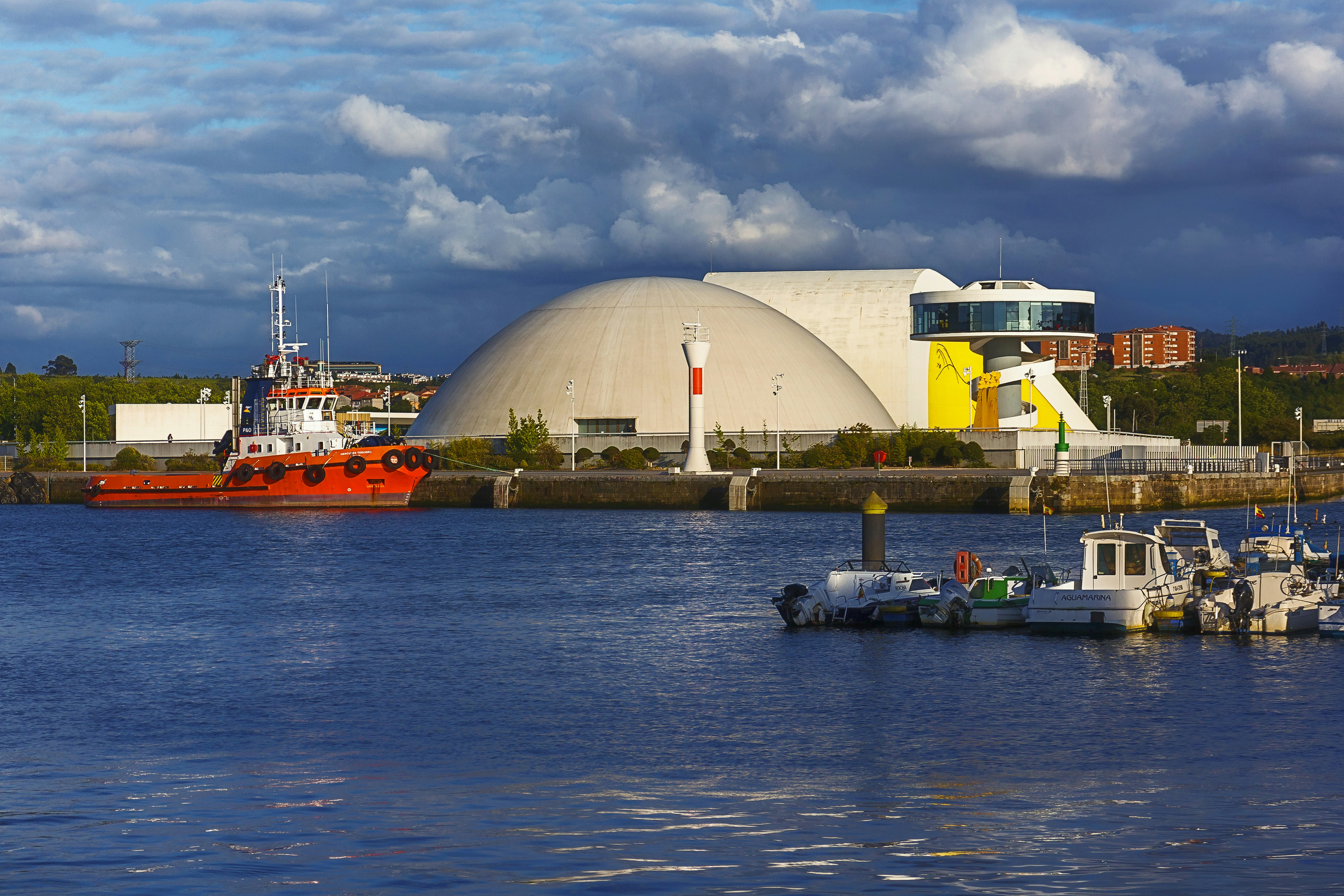 white and orange ship on dock near white building during daytime