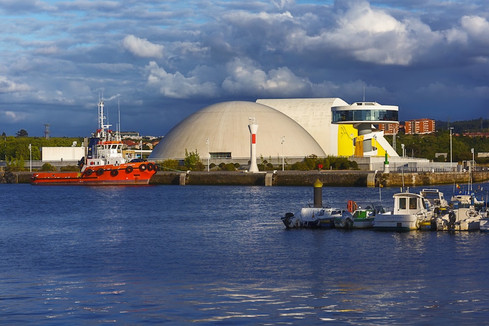 white and orange ship on dock near white building during daytime