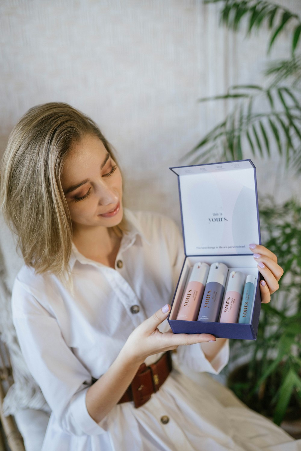 Woman smiling while opening a product box