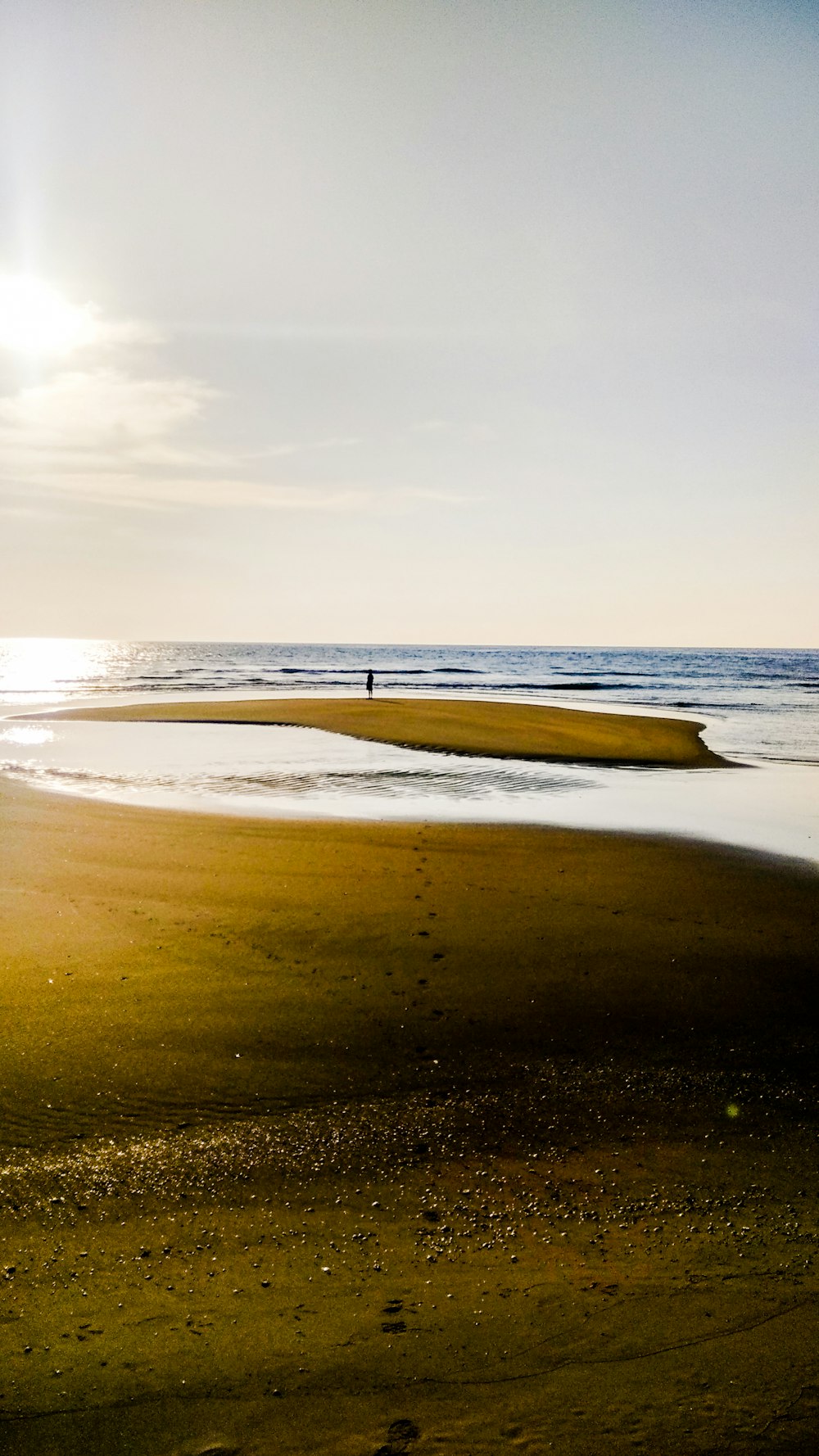 person walking on beach during daytime