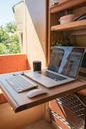 macbook pro on brown wooden table