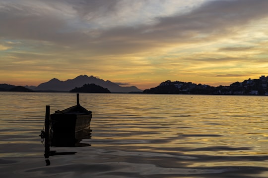 brown wooden dock on body of water during sunset in Cariacica Brasil