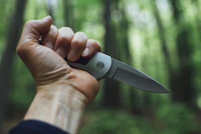 person holding camping knife
