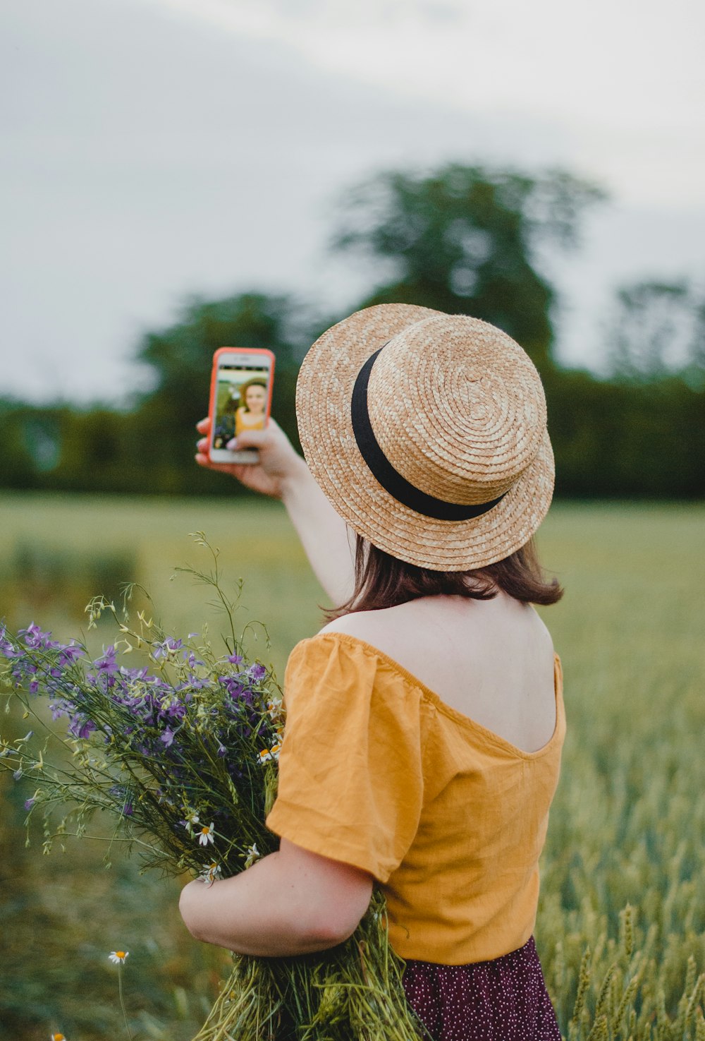 woman in yellow shirt holding iphone 6