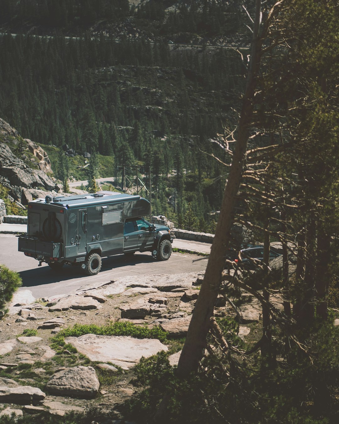 green and white truck on gray rocky road during daytime