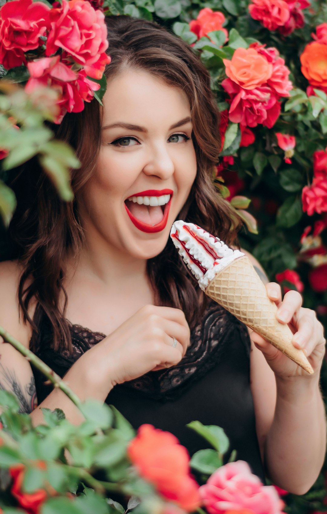 woman in black dress holding ice cream cone