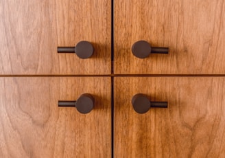 black round buttons on brown wooden surface