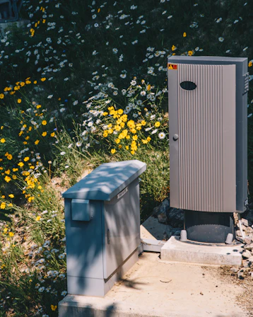 gray and black speaker beside green tree