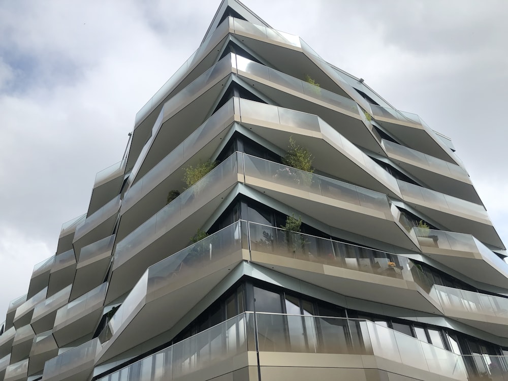 white concrete building under white clouds during daytime