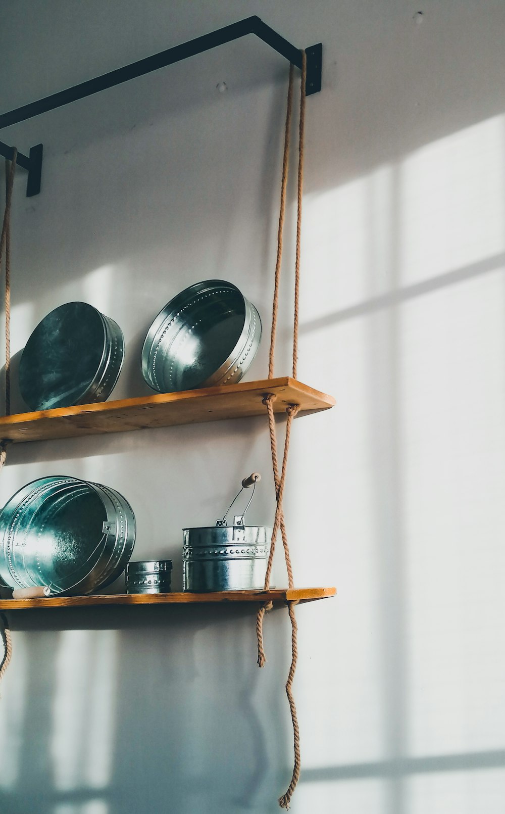 brown wooden shelf with blue ceramic bowls