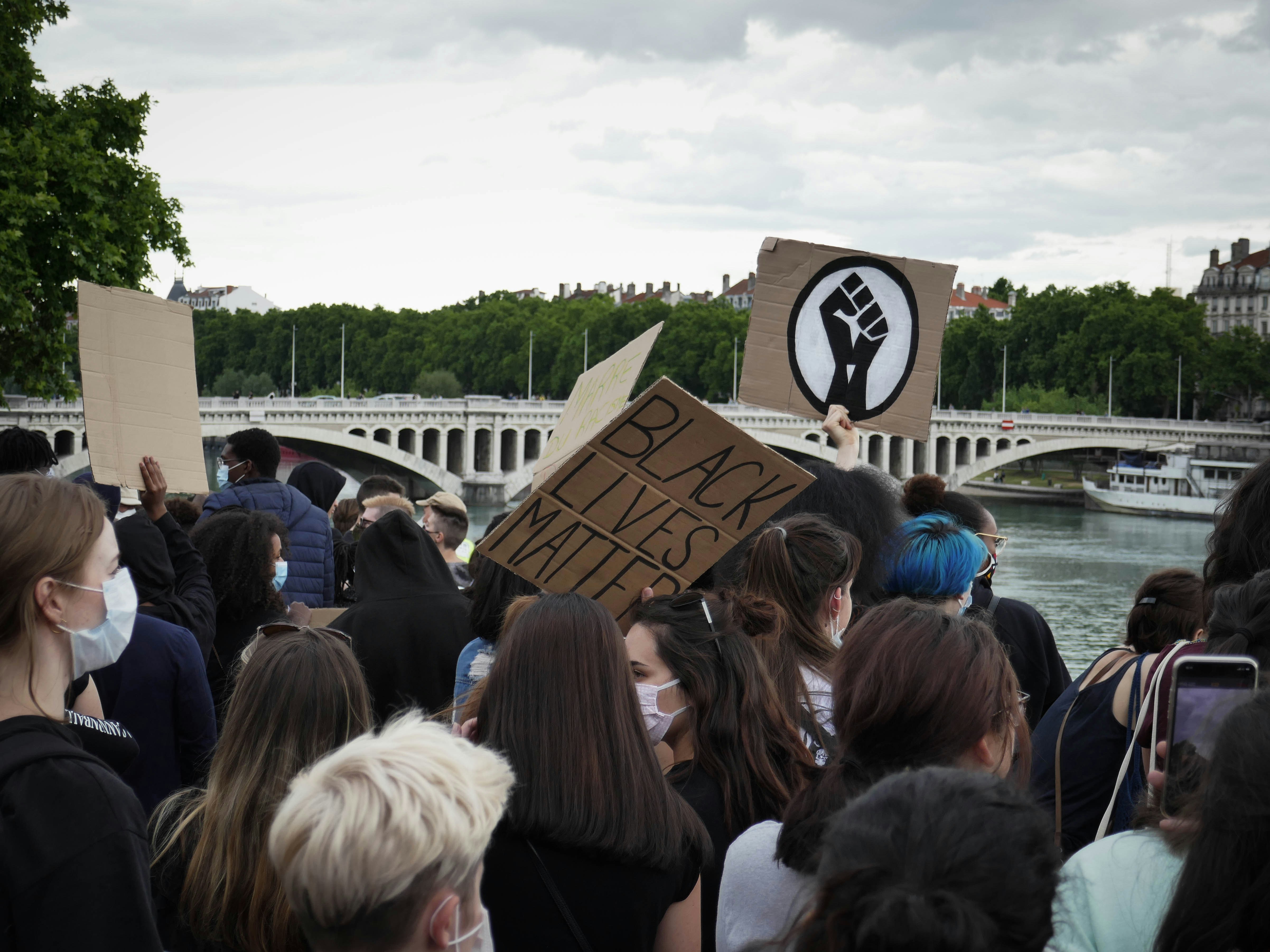 people gathering near body of water during daytime