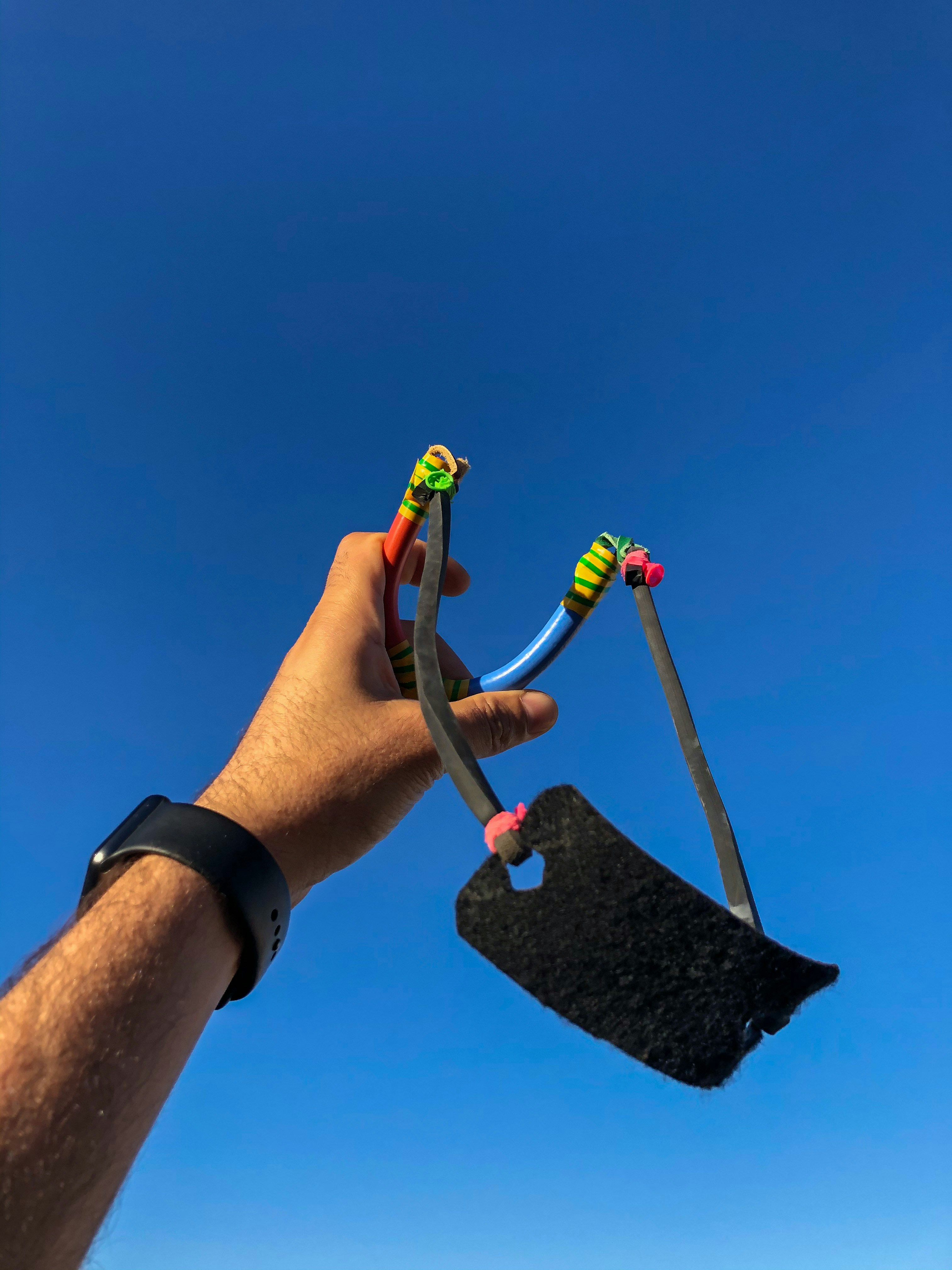 person holding black and yellow plastic toy