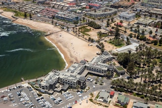 aerial view of city buildings and green grass field during daytime