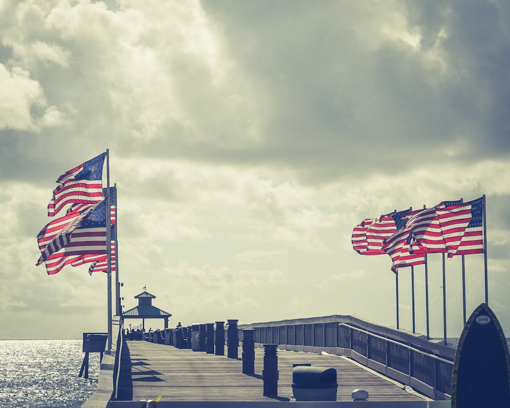 us a flag on wooden dock during daytime