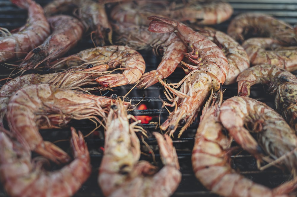 a bunch of shrimp is cooking on a grill