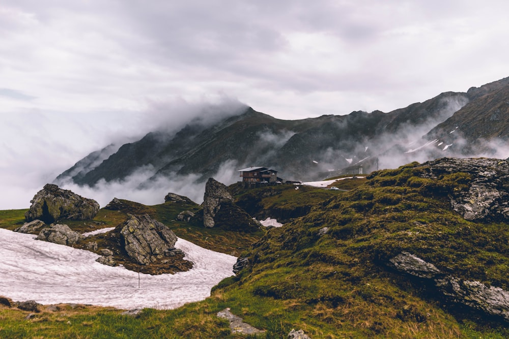 green and black mountain under white clouds during daytime