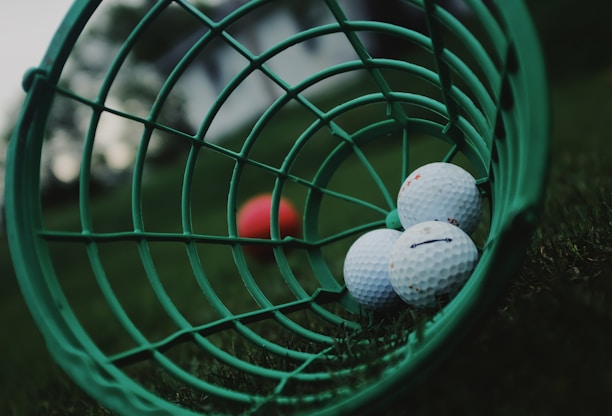 white golf ball on green basket
