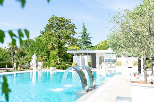 white outdoor fountain near green trees during daytime in Montegrotto Terme Italy