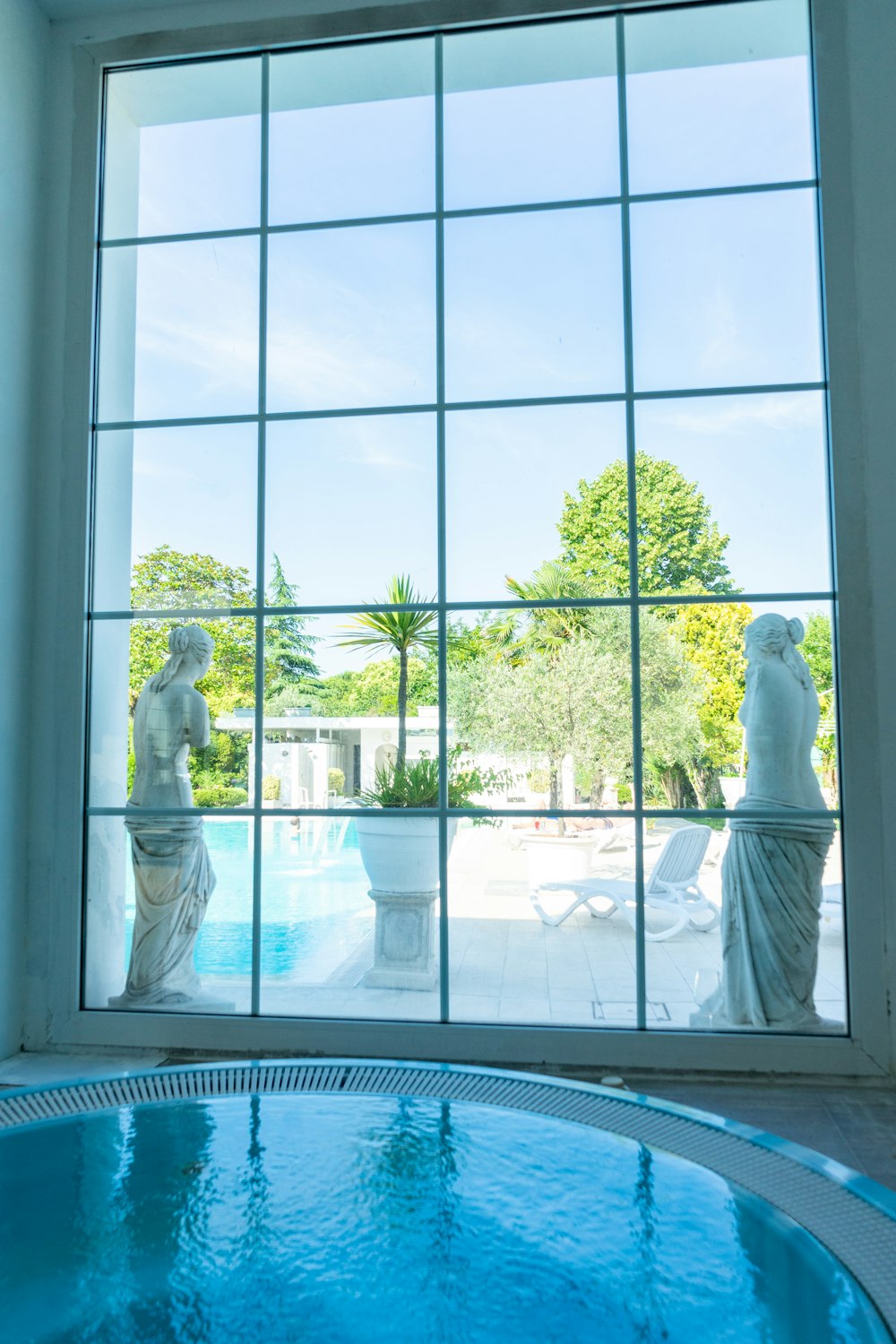 man in white thobe standing on white floor tiles during daytime