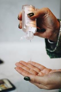 person holding clear plastic bottle