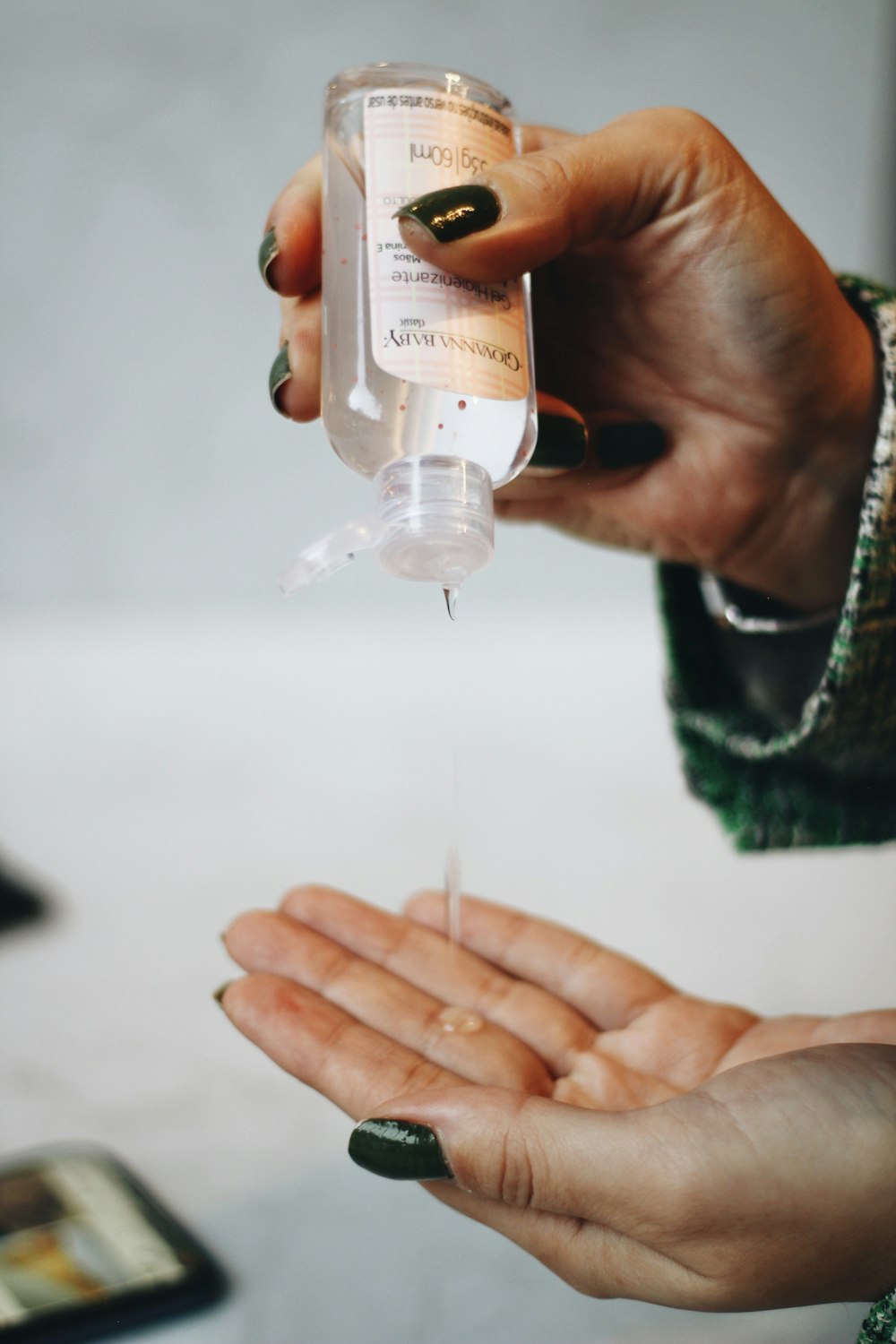 person holding clear plastic bottle