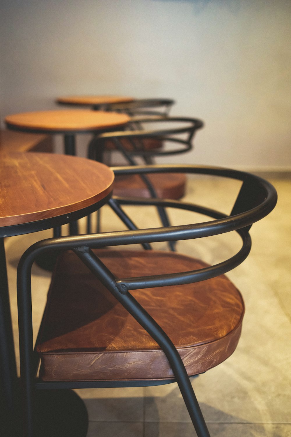 black metal framed brown wooden round table