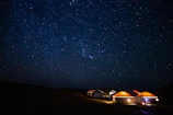 Night view of Yatrinest’s exterior lit softly under the stars.