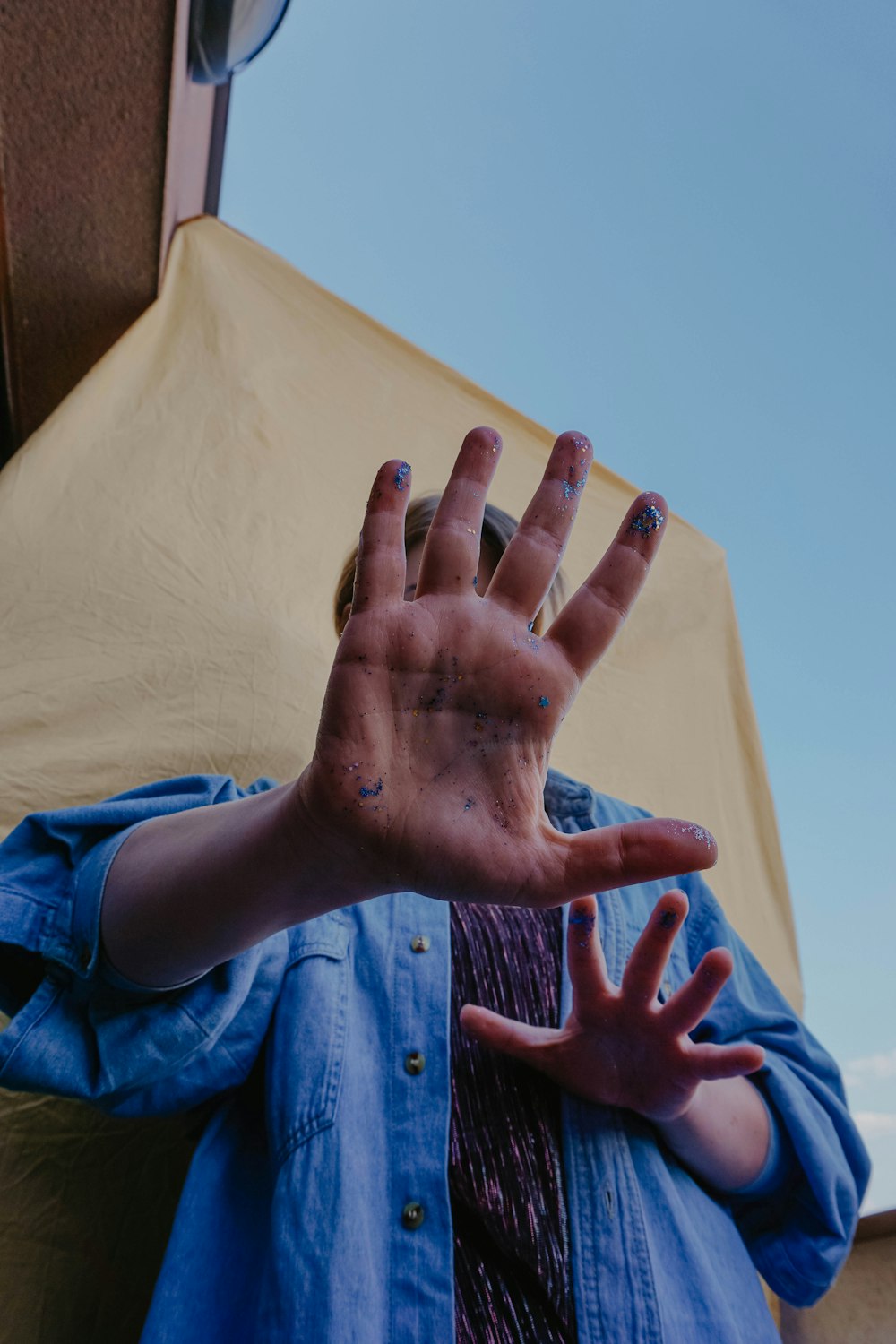 person in blue button up shirt holding white textile