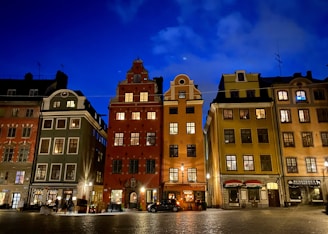 A vibrant photo of a historic European street bustling with tourists under moody evening skies.