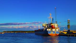 Bright and clear image of cargo ships docked at Panama's main port under a sunny sky