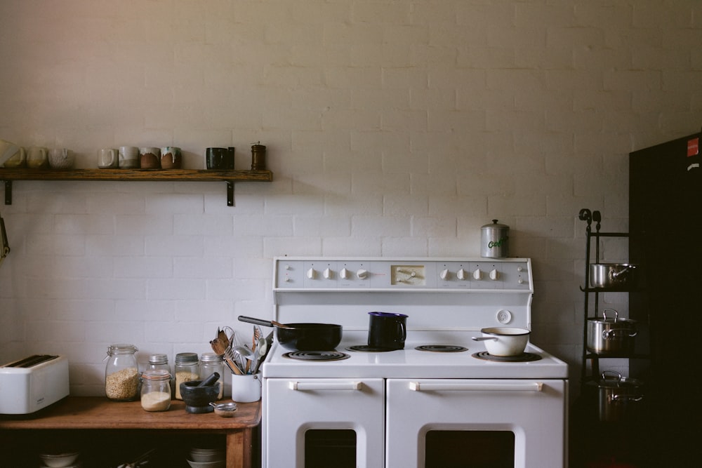 white gas range oven with cooking pots