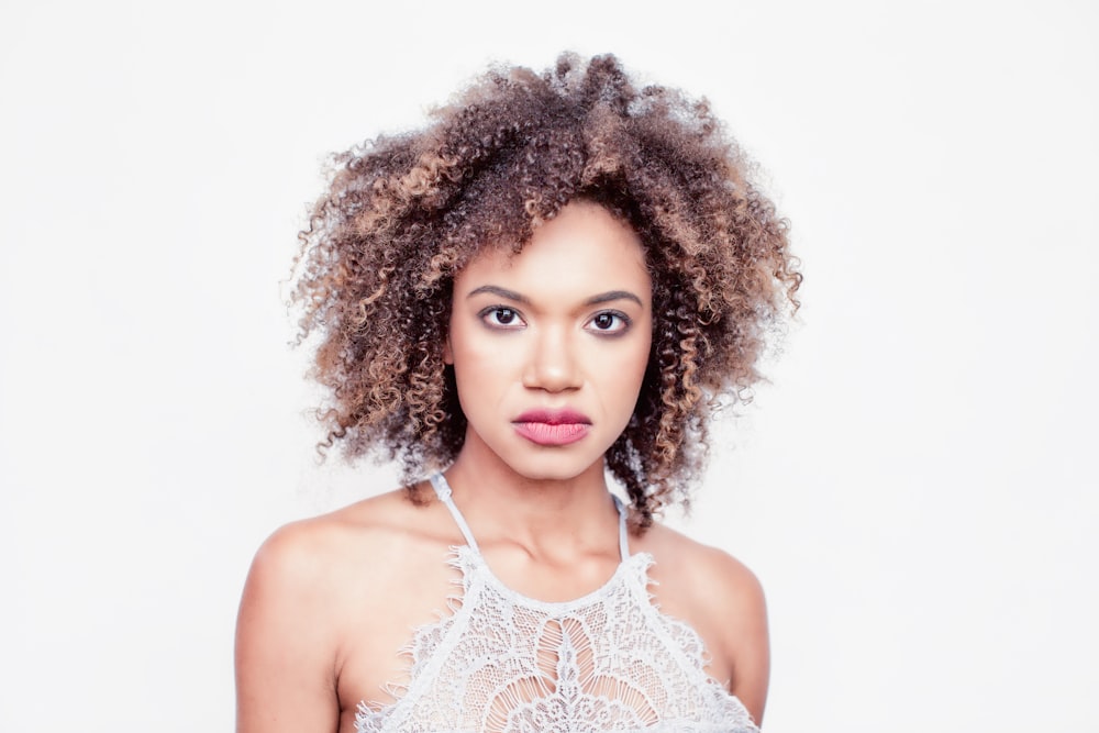 woman in white lace spaghetti strap top