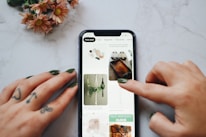 Close-up of hands optimizing a Pinterest profile on a tablet.