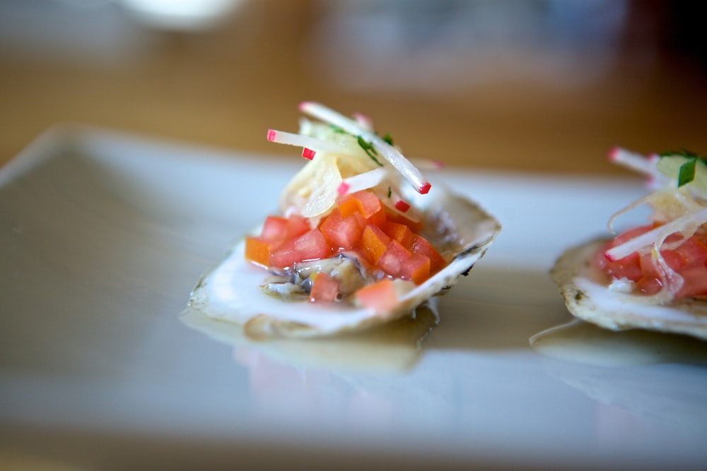 sliced tomato and green vegetable on white ceramic plate