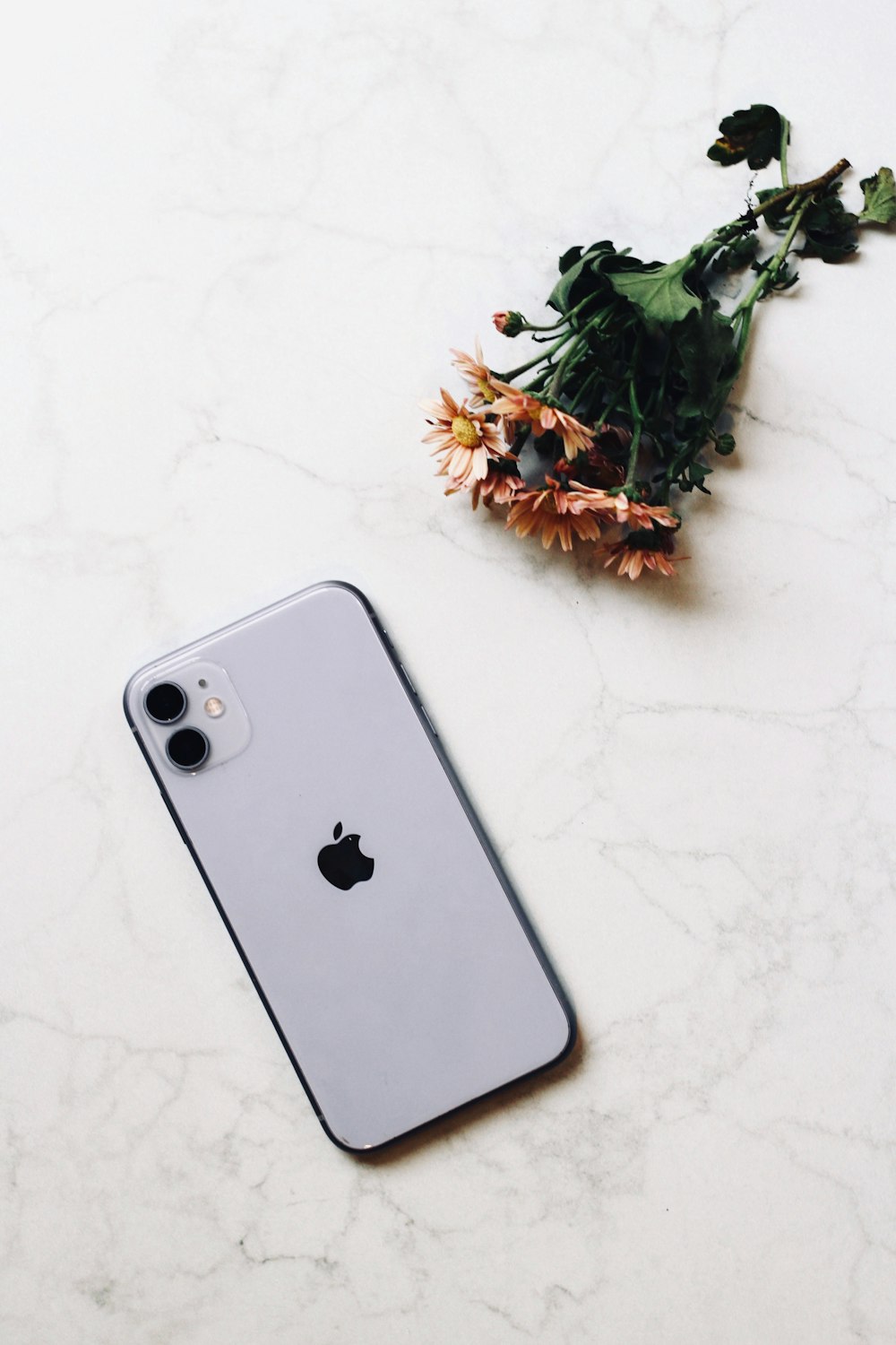 silver iphone 6 on white surface