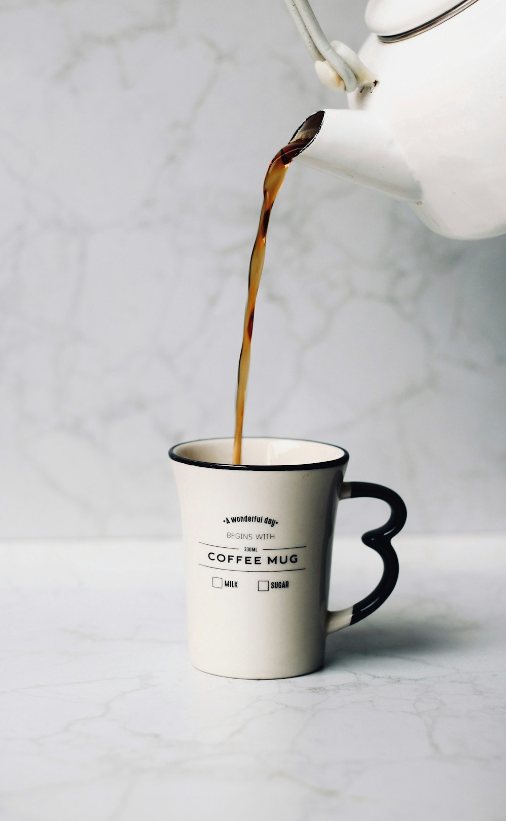 white ceramic mug with brown liquid