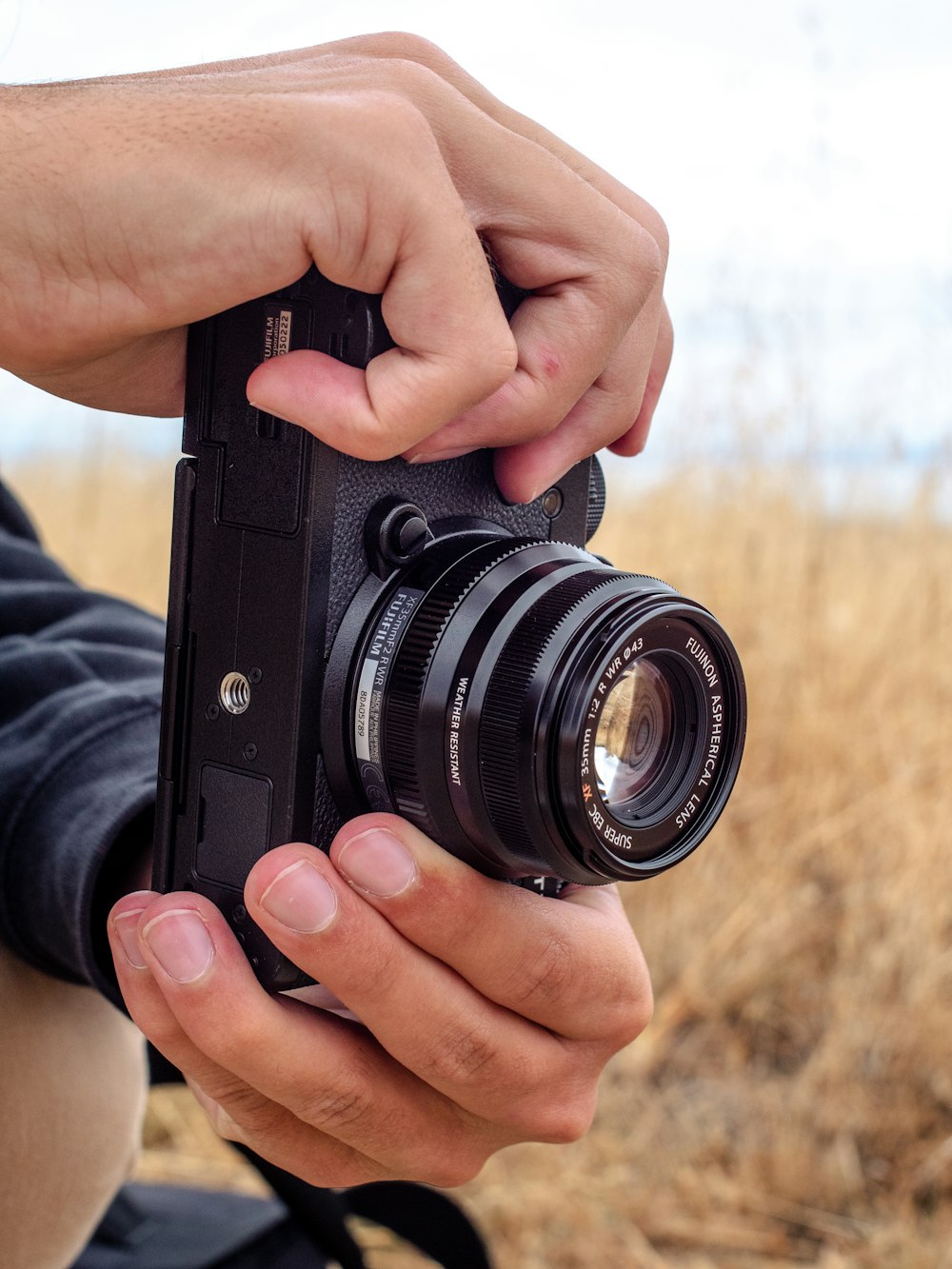 person holding black dslr camera