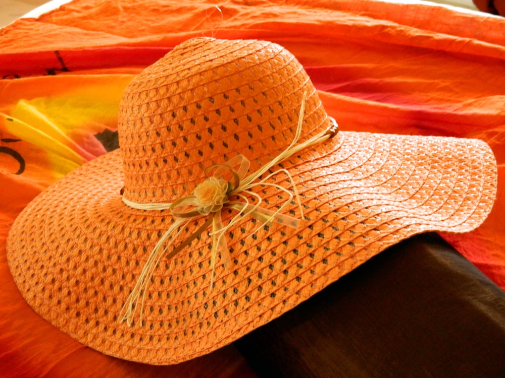 brown straw hat on black textile