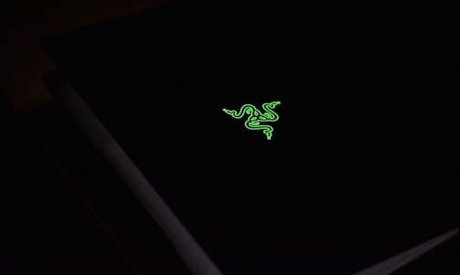 A green logo of nfourteen displayed on a sleek digital screen