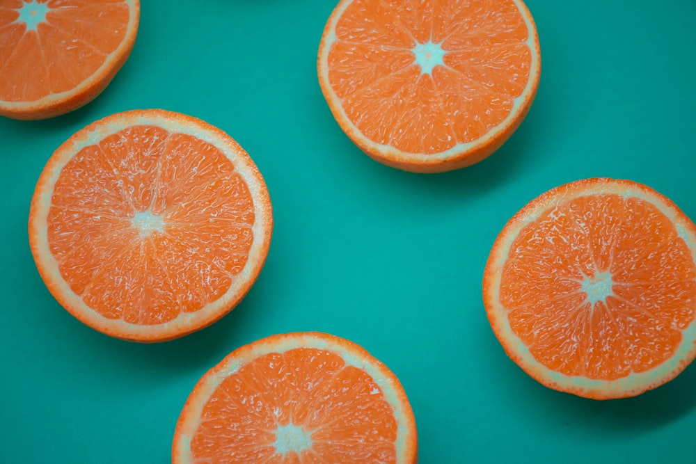 sliced orange fruit on blue surface