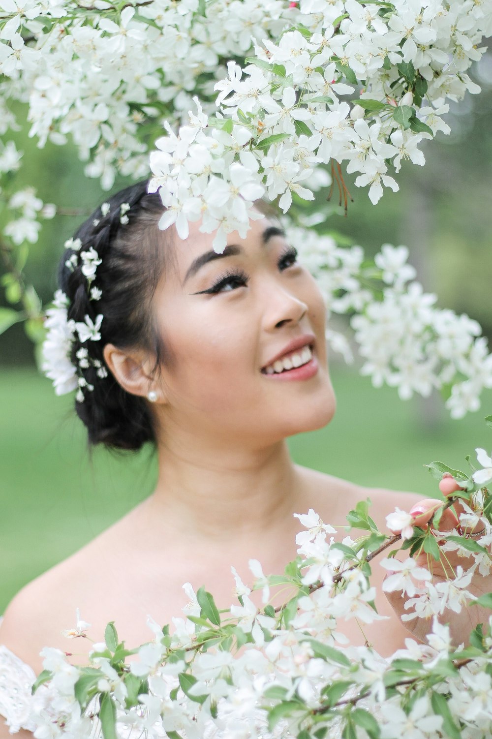smiling woman with white flowers on her head