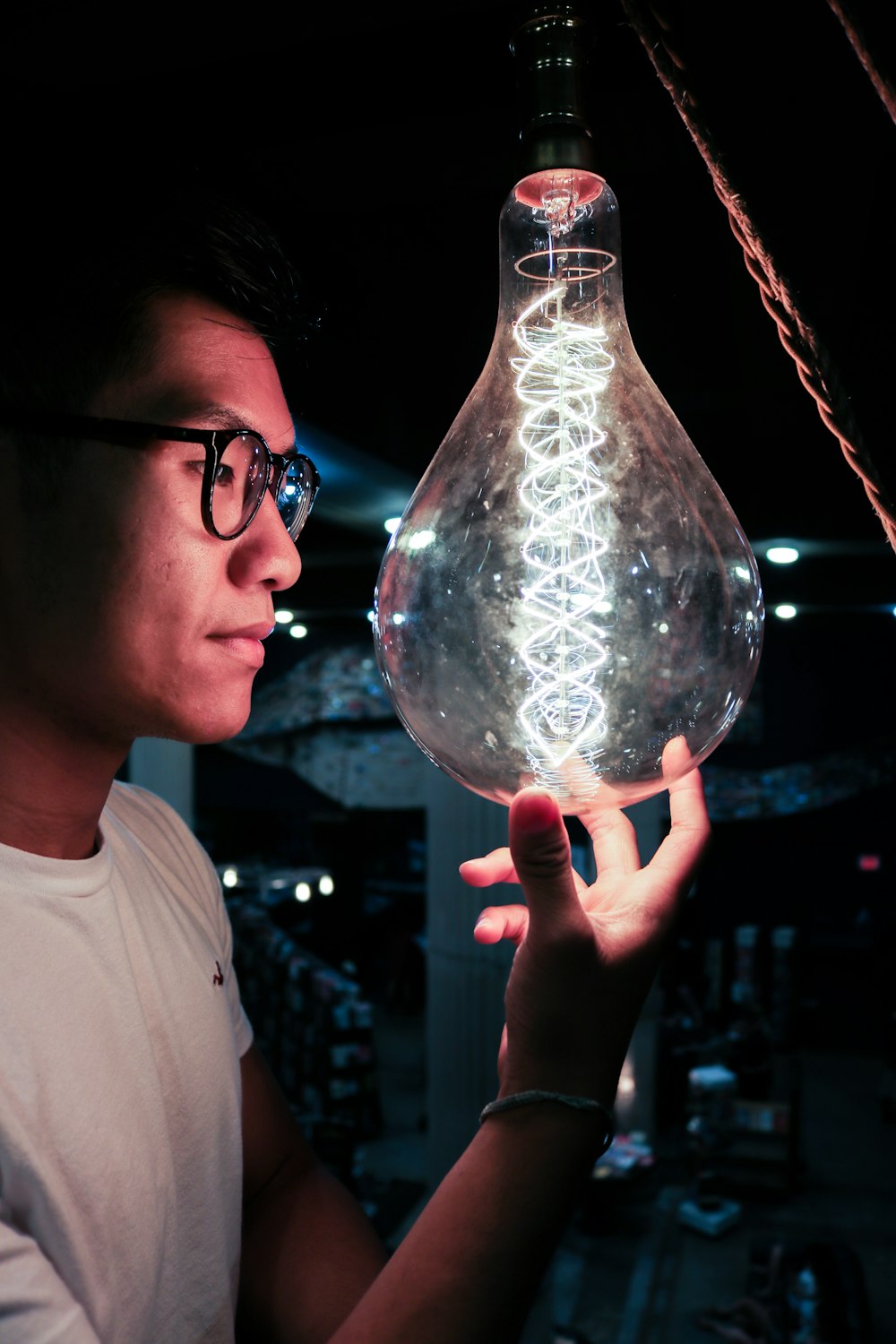 boy in white crew neck shirt holding clear glass ball