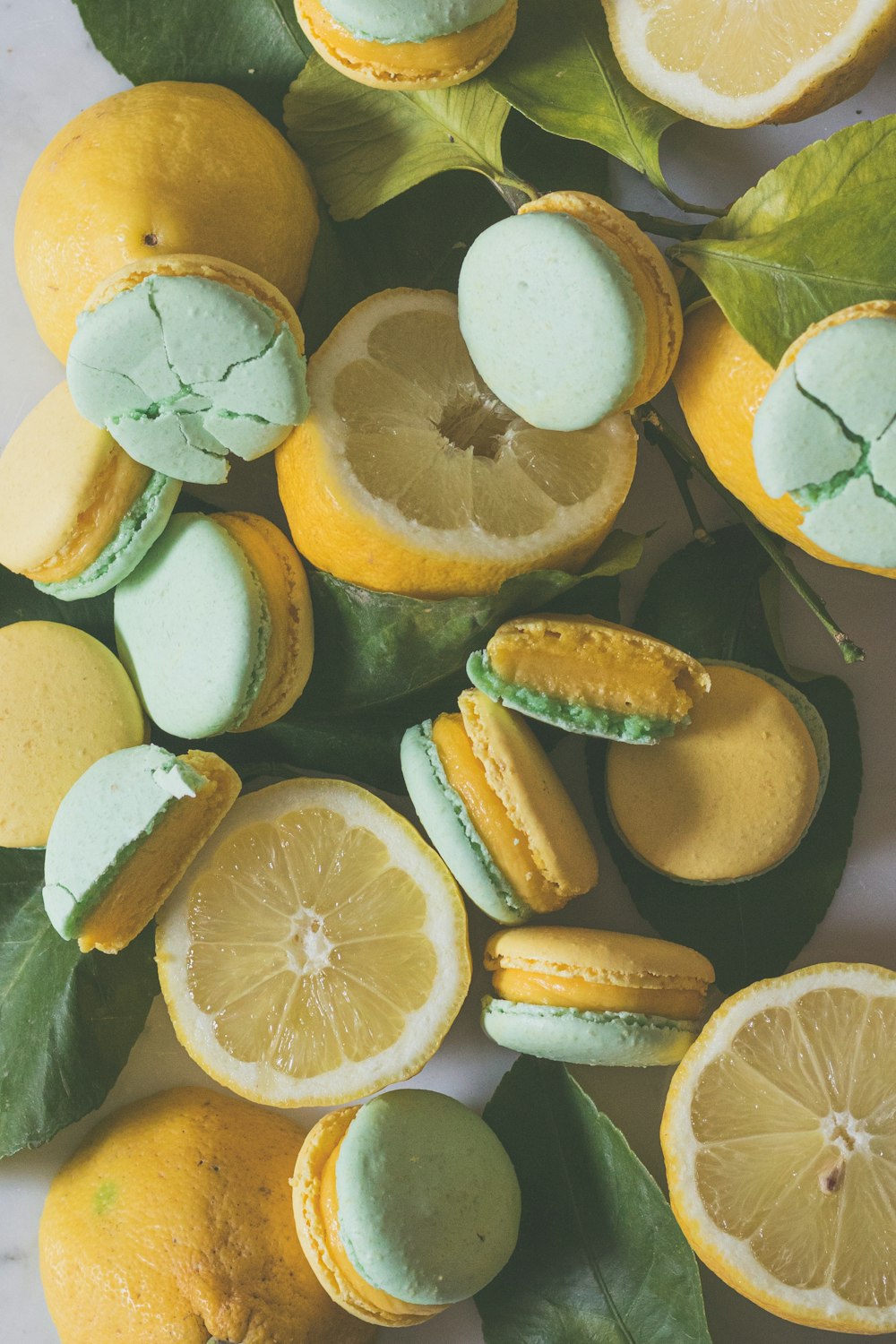 sliced lemon and green lemon on water