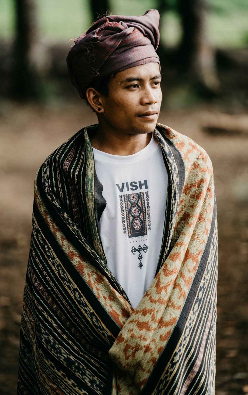 man in white crew neck shirt and black and white scarf