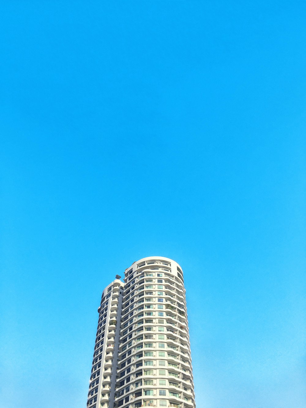 white and blue concrete building under blue sky during daytime