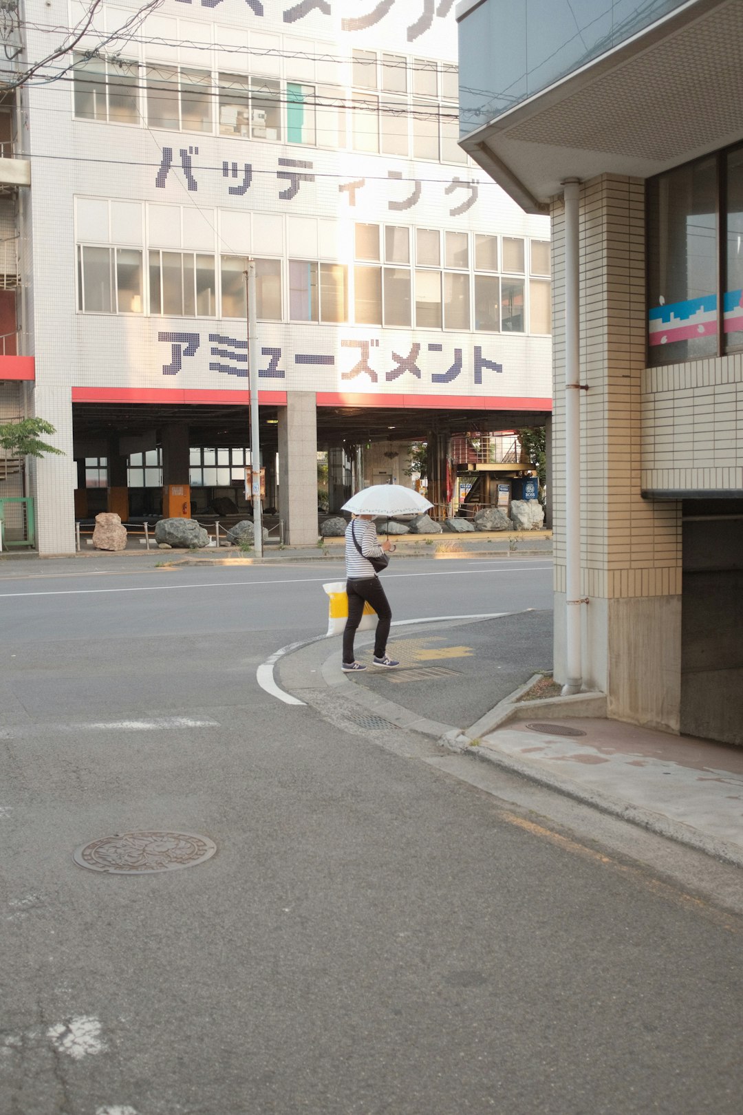 woman in black jacket and black pants walking on sidewalk during daytime