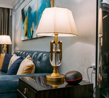 brass and white table lamp on brown wooden table