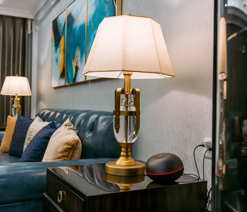 brass and white table lamp on brown wooden table