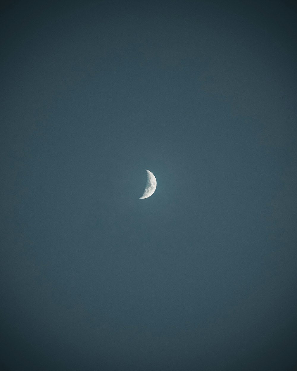 white crescent moon in blue sky